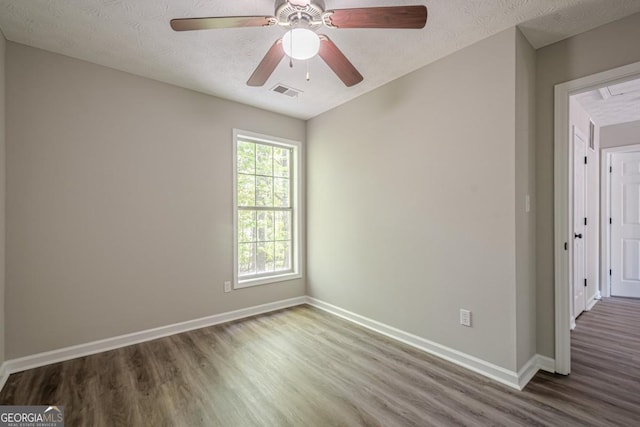 1331 Windage Ct SW, Marietta, GA 30008 - unfurnished room featuring wood finished floors, a textured ceiling, and ceiling fan