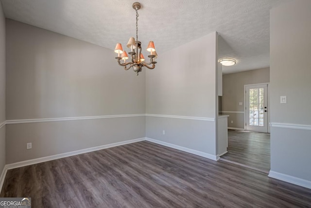 1331 Windage Ct SW, Marietta, GA 30008 - empty room featuring a chandelier, dark wood finished floors, and a textured ceiling