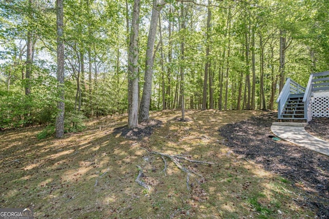 1331 Windage Ct SW, Marietta, GA 30008 - view of yard with a wooden deck, stairway, and a view of trees