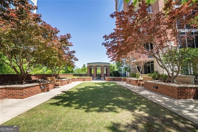 surrounding community featuring a gazebo and a lawn