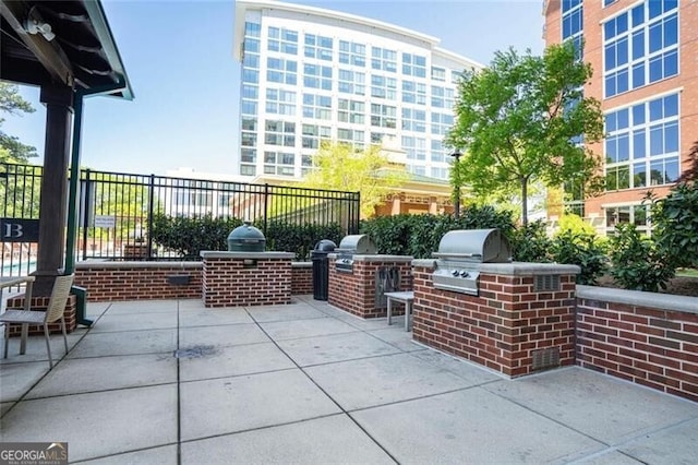 view of patio / terrace with area for grilling and fence