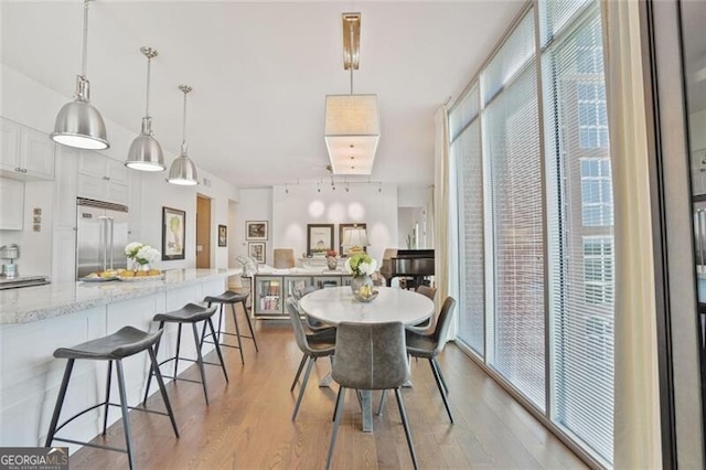 dining room featuring a wealth of natural light and wood finished floors