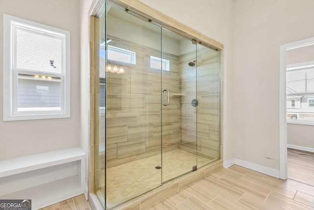 full bathroom featuring baseboards and a stall shower