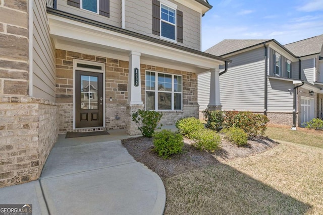 property entrance featuring stone siding and covered porch