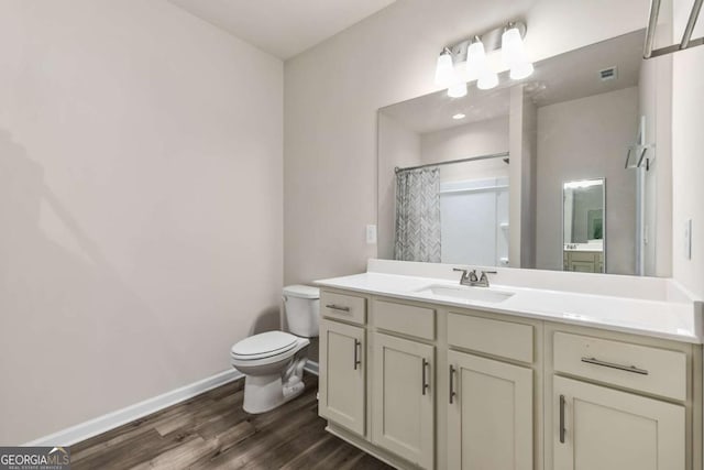 bathroom with toilet, baseboards, wood finished floors, a shower with shower curtain, and vanity