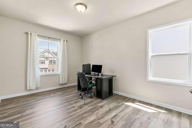office space with wood finished floors and baseboards
