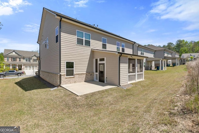 back of property featuring a yard and a patio area