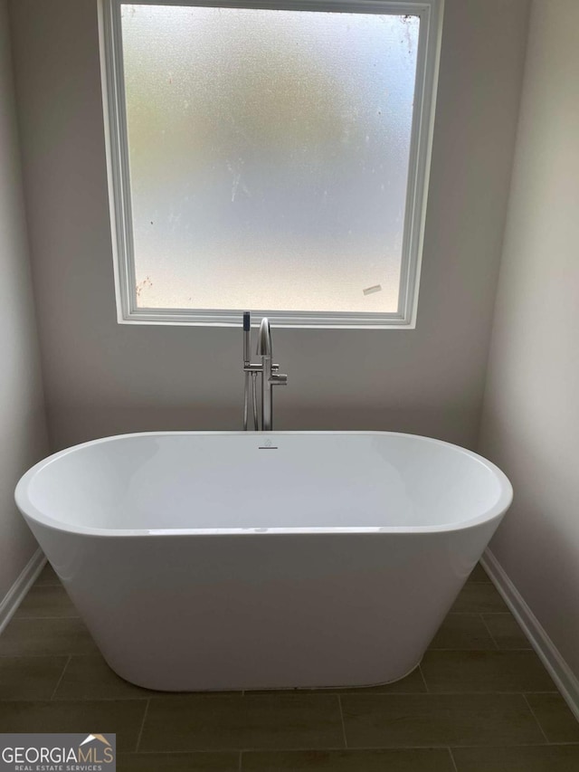 124 Shenandoah Ln, Lagrange, GA 30241 - full bathroom with a soaking tub, tile patterned flooring, and baseboards