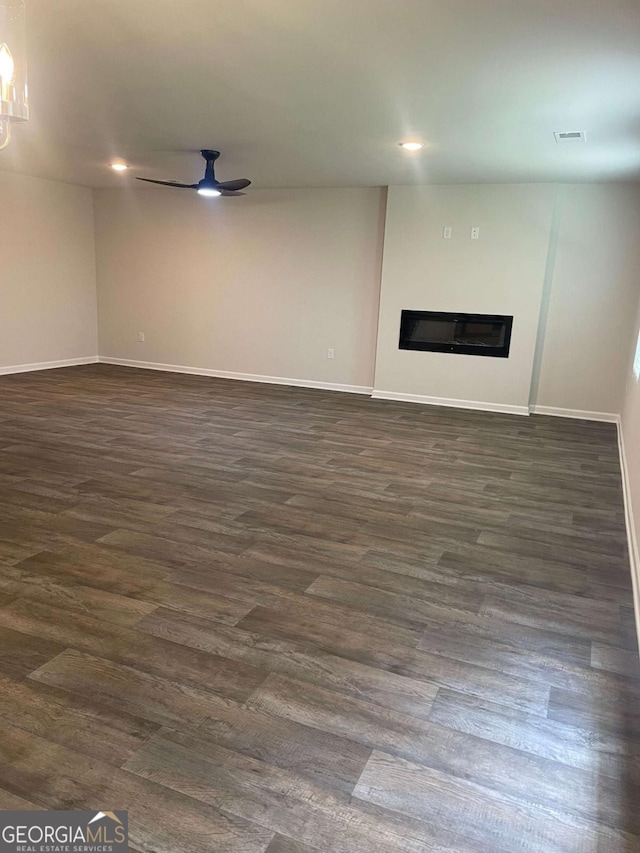 124 Shenandoah Ln, Lagrange, GA 30241 - unfurnished living room featuring dark wood finished floors, a glass covered fireplace, and baseboards