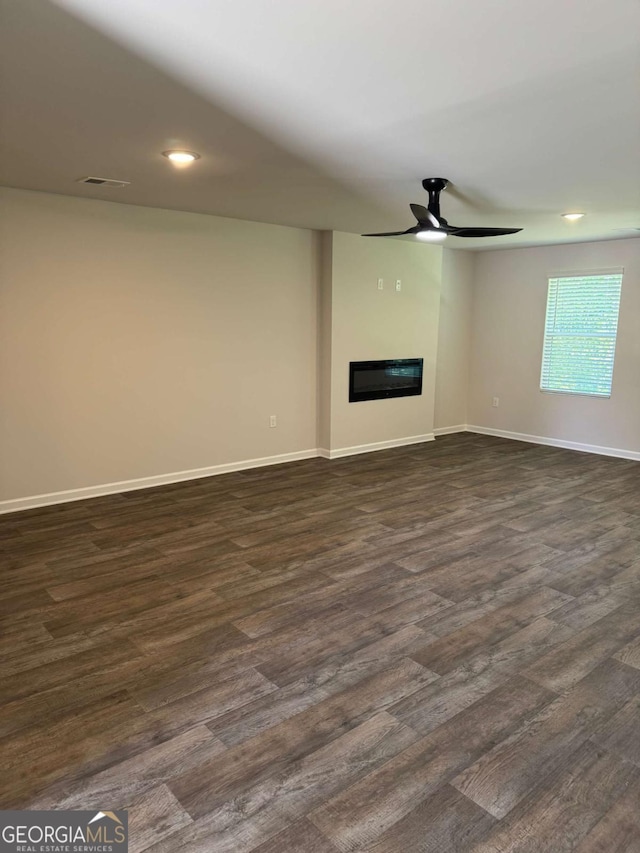124 Shenandoah Ln, Lagrange, GA 30241 - unfurnished living room with dark wood-style flooring, baseboards, a glass covered fireplace, recessed lighting, and ceiling fan