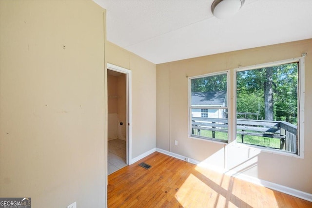 interior space with light wood finished floors, visible vents, and plenty of natural light