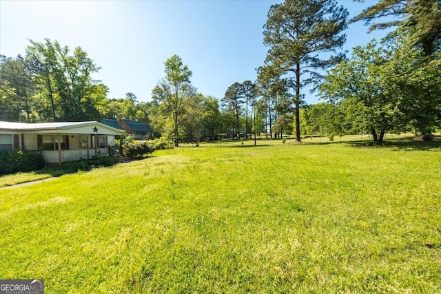 view of yard featuring covered porch