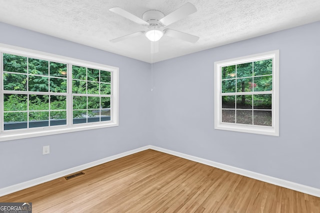 201 Oakdale Dr, Cornelia, GA 30531 - spare room featuring baseboards, wood finished floors, a ceiling fan, and a textured ceiling