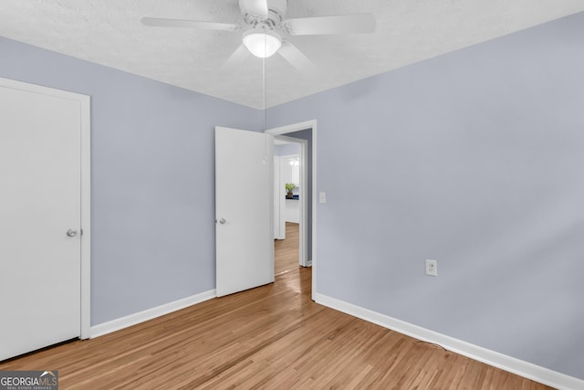 201 Oakdale Dr, Cornelia, GA 30531 - empty room featuring a ceiling fan, baseboards, wood finished floors, and a textured ceiling