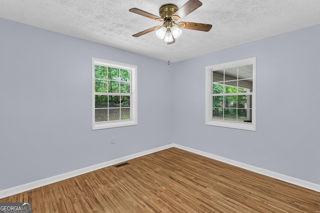 201 Oakdale Dr, Cornelia, GA 30531 - empty room with baseboards, wood finished floors, a textured ceiling, and a ceiling fan