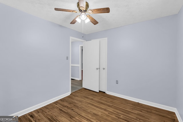 201 Oakdale Dr, Cornelia, GA 30531 - empty room with a ceiling fan, baseboards, wood finished floors, and a textured ceiling