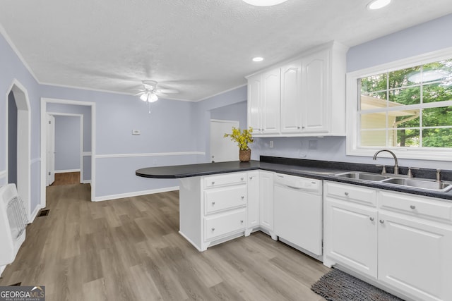 201 Oakdale Dr, Cornelia, GA 30531 - kitchen featuring dishwasher, a sink, a peninsula, ceiling fan, and dark countertops