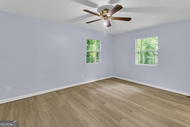 201 Oakdale Dr, Cornelia, GA 30531 - empty room with light wood-style floors, healthy amount of natural light, baseboards, and a ceiling fan