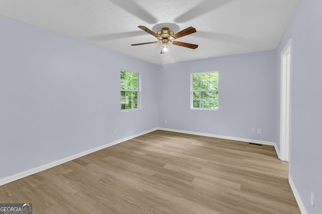 201 Oakdale Dr, Cornelia, GA 30531 - empty room with plenty of natural light, ceiling fan, and baseboards