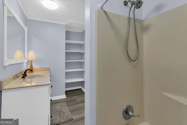 201 Oakdale Dr, Cornelia, GA 30531 - bathroom with a textured ceiling, wood finished floors, bathtub / shower combination, vanity, and ornamental molding