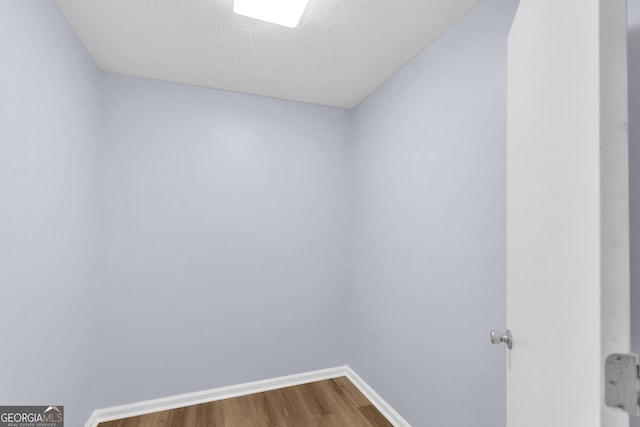 201 Oakdale Dr, Cornelia, GA 30531 - empty room with dark wood finished floors, baseboards, and a textured ceiling