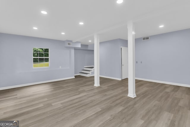 201 Oakdale Dr, Cornelia, GA 30531 - below grade area with baseboards, wood finished floors, recessed lighting, and stairs