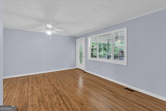 201 Oakdale Dr, Cornelia, GA 30531 - unfurnished room featuring ornamental molding, wood finished floors, baseboards, a ceiling fan, and a textured ceiling
