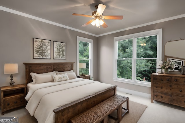 bedroom with crown molding, visible vents, baseboards, ceiling fan, and carpet flooring