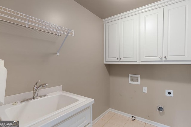 clothes washing area with electric dryer hookup, cabinet space, a sink, baseboards, and hookup for a washing machine