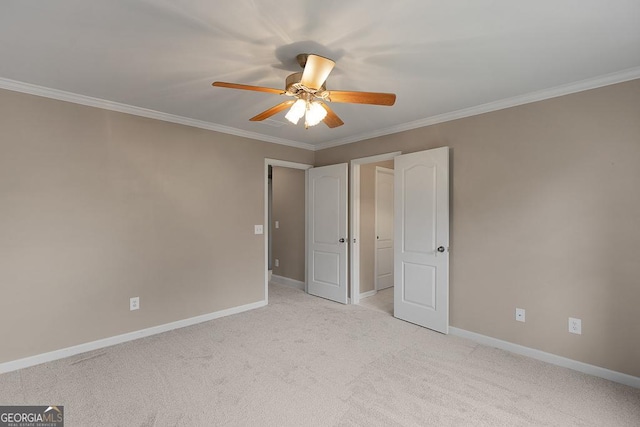 unfurnished bedroom featuring crown molding, baseboards, a ceiling fan, and light colored carpet