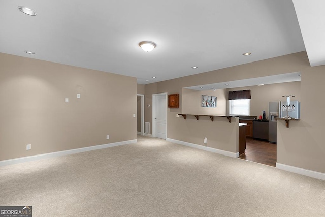 unfurnished living room featuring baseboards, light carpet, recessed lighting, and visible vents