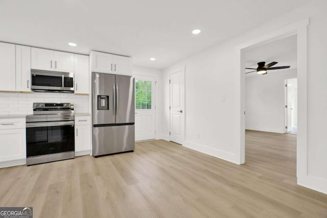 kitchen featuring baseboards, white cabinetry, light wood-style floors, light countertops, and appliances with stainless steel finishes