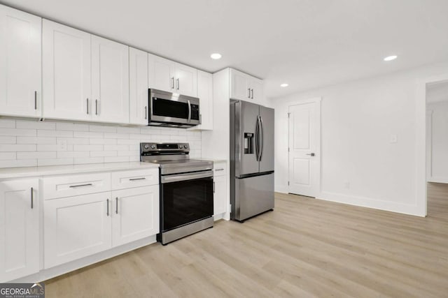 kitchen featuring white cabinets, recessed lighting, stainless steel appliances, light countertops, and light wood-style flooring