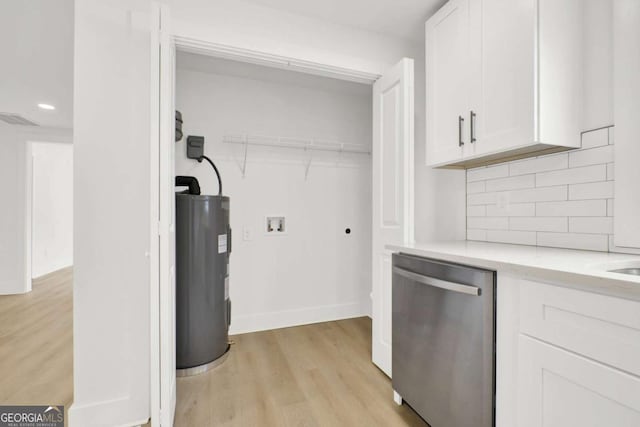 clothes washing area with hookup for a washing machine, electric water heater, light wood-style floors, visible vents, and recessed lighting