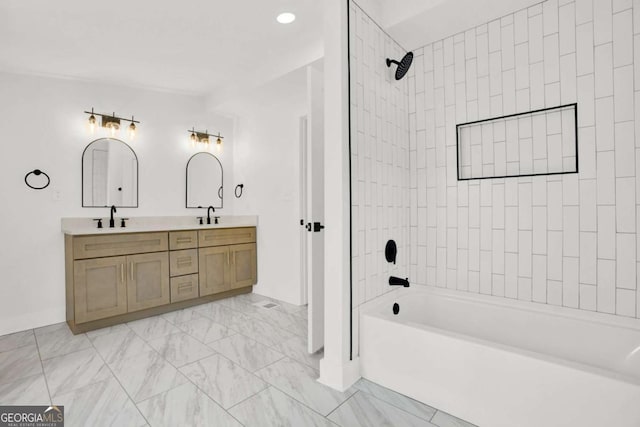 bathroom with baseboards, a sink, double vanity, and bathing tub / shower combination