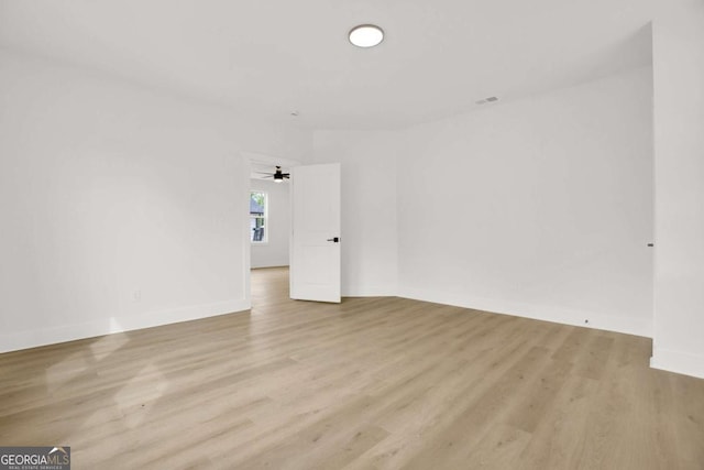 empty room featuring wood finished floors and baseboards