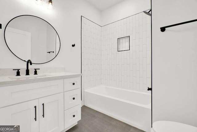 bathroom featuring toilet, shower / bathtub combination, and vanity