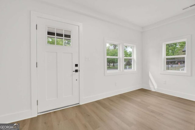 entrance foyer featuring light wood-style floors and plenty of natural light