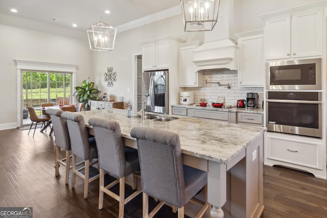 906 Abingdon Cv, Bonaire, GA 31005 - kitchen with appliances with stainless steel finishes, a chandelier, backsplash, dark wood-style flooring, and recessed lighting