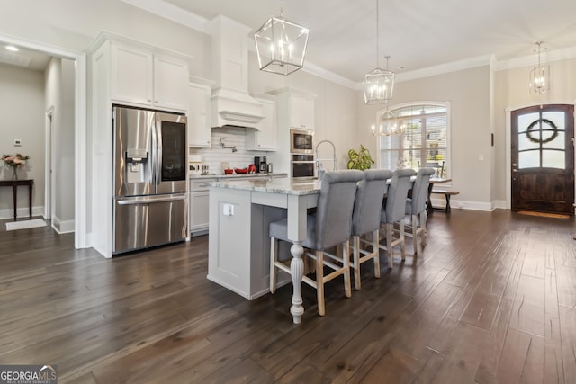 906 Abingdon Cv, Bonaire, GA 31005 - kitchen with appliances with stainless steel finishes, a chandelier, backsplash, white cabinetry, and crown molding