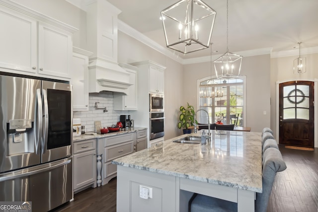 906 Abingdon Cv, Bonaire, GA 31005 - kitchen featuring stainless steel appliances, dark wood-style floors, decorative backsplash, a breakfast bar, and ornamental molding