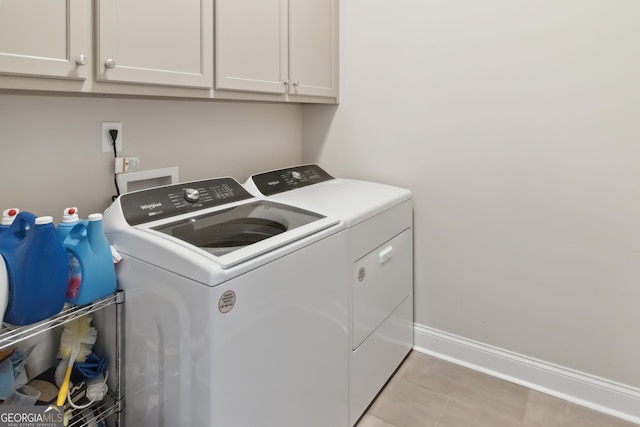906 Abingdon Cv, Bonaire, GA 31005 - laundry area with separate washer and dryer, cabinet space, and light tile patterned flooring