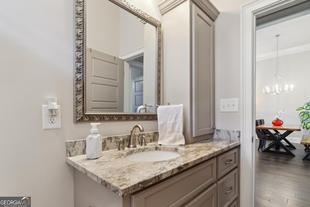 906 Abingdon Cv, Bonaire, GA 31005 - bathroom featuring a chandelier, vanity, and wood finished floors