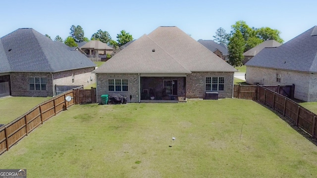 906 Abingdon Cv, Bonaire, GA 31005 - back of property with a fenced backyard, brick siding, and roof with shingles