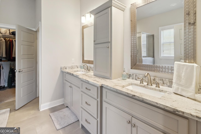 906 Abingdon Cv, Bonaire, GA 31005 - bathroom with double vanity, a walk in closet, and an enclosed shower
