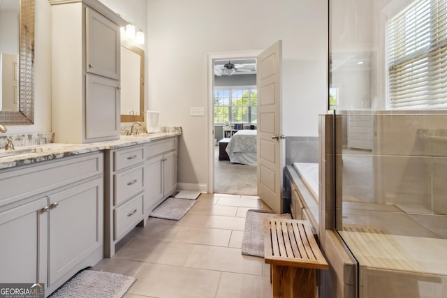 906 Abingdon Cv, Bonaire, GA 31005 - ensuite bathroom with double vanity, ceiling fan, a bath, and tile patterned flooring