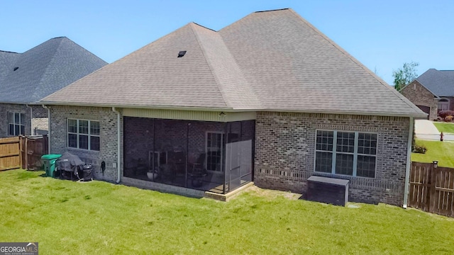 906 Abingdon Cv, Bonaire, GA 31005 - rear view of property featuring brick siding, a sunroom, and a fenced backyard