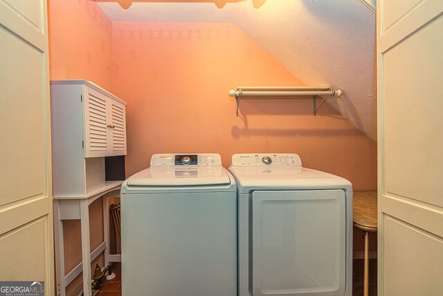 clothes washing area with washing machine and dryer