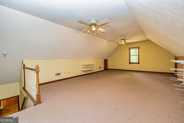 bonus room featuring carpet floors, ceiling fan, lofted ceiling, and baseboards