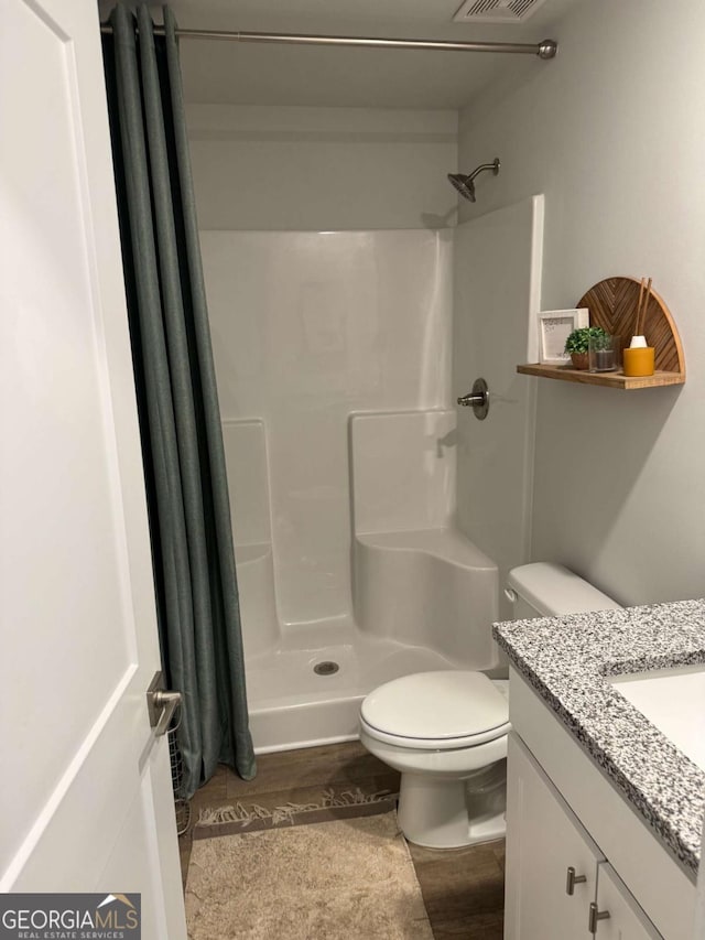 719 Windstream Dr Unit B61, Lagrange, GA 30241 - full bath with toilet, wood finished floors, a stall shower, visible vents, and vanity